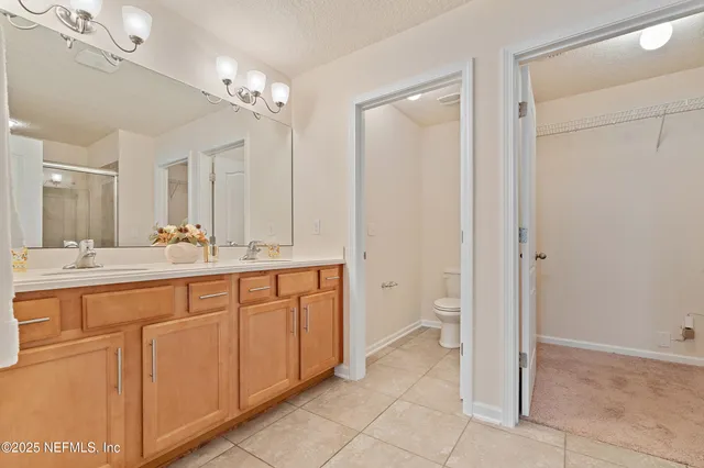 a spacious bathroom with a granite countertop sink a mirror and a vanity