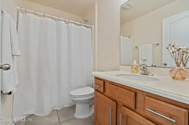 a bedroom with a bed dresser and a window