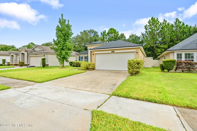 a front view of a house with a yard and garage