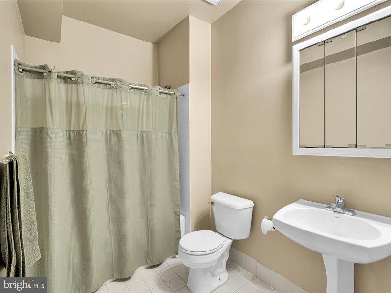 2 Canals End Road, Unit 305 Bristol, PA 19007 - Photo 11 of 22 a bathroom with a sink a toilet and a mirror