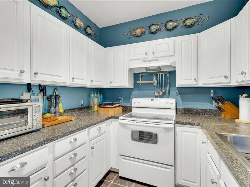 2 Canals End Road, Unit 305 Bristol, PA 19007 - Photo 13 of 22 a kitchen with granite countertop white cabinets and white appliances