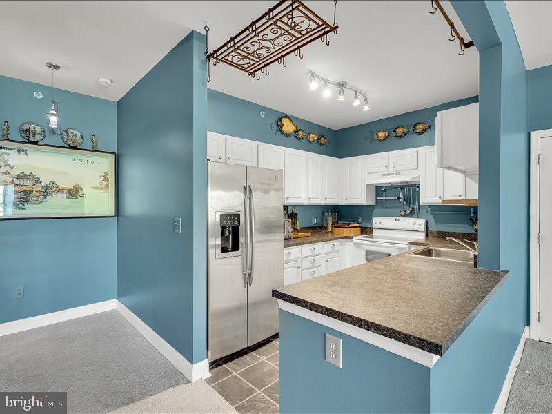 2 Canals End Road, Unit 305 Bristol, PA 19007 - Photo 16 of 22 a kitchen with stainless steel appliances granite countertop a refrigerator a stove and a sink