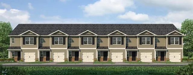 a view of a large white house with wooden fence