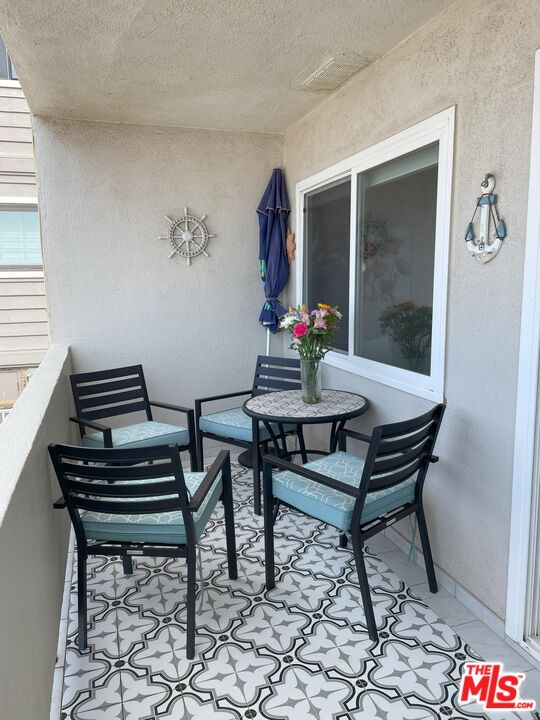 4975 Sandyland Road, Unit 212 Carpinteria, CA 93013 - Photo 11 of 18 a living room with a piano and a table