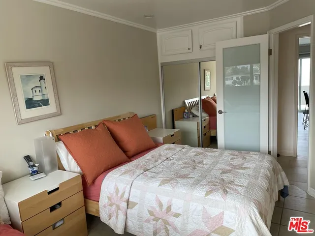 a bedroom with a bed and a mirror