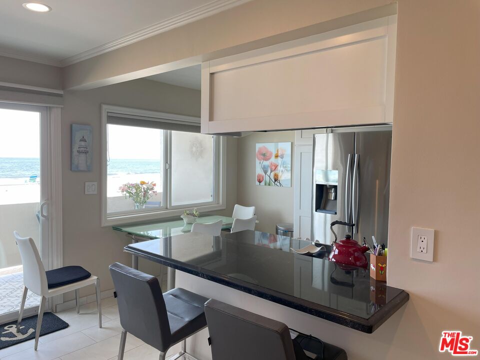 4975 Sandyland Road, Unit 212 Carpinteria, CA 93013 - Photo 4 of 18 a dining room with table and chairs