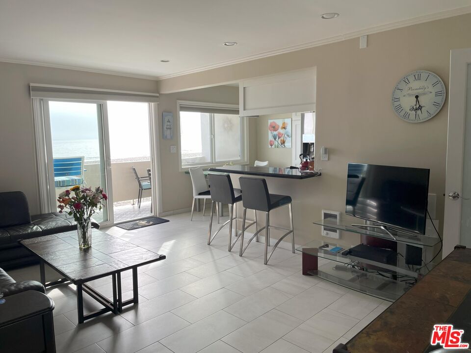 4975 Sandyland Road, Unit 212 Carpinteria, CA 93013 - Photo 6 of 18 a view of a dining room with furniture and chandelier