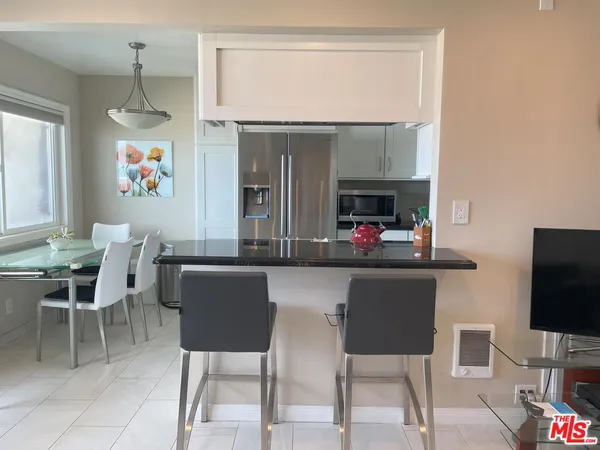 a dinning room with chairs and a flat screen tv