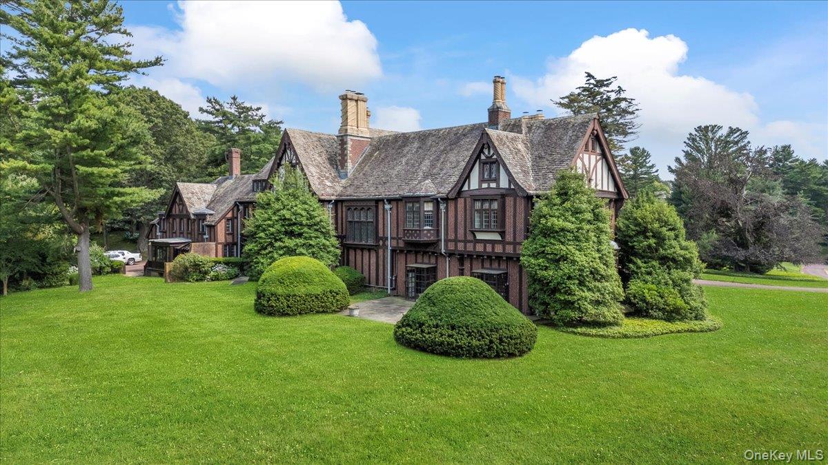 127 Horseshoe Road Mill Neck, NY 11765 - Photo 12 of 48 a view of a big house with a big yard and potted plants