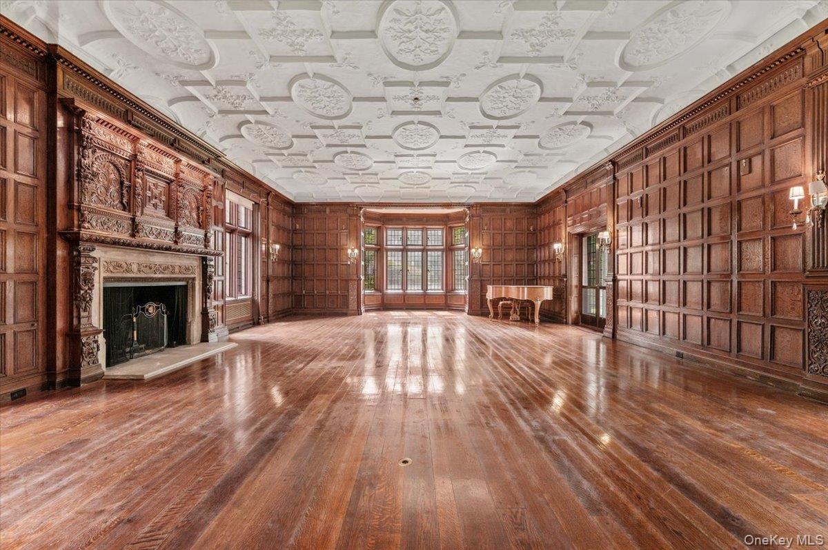 127 Horseshoe Road Mill Neck, NY 11765 - Photo 16 of 48 a view of an empty room with wooden floor and a fireplace