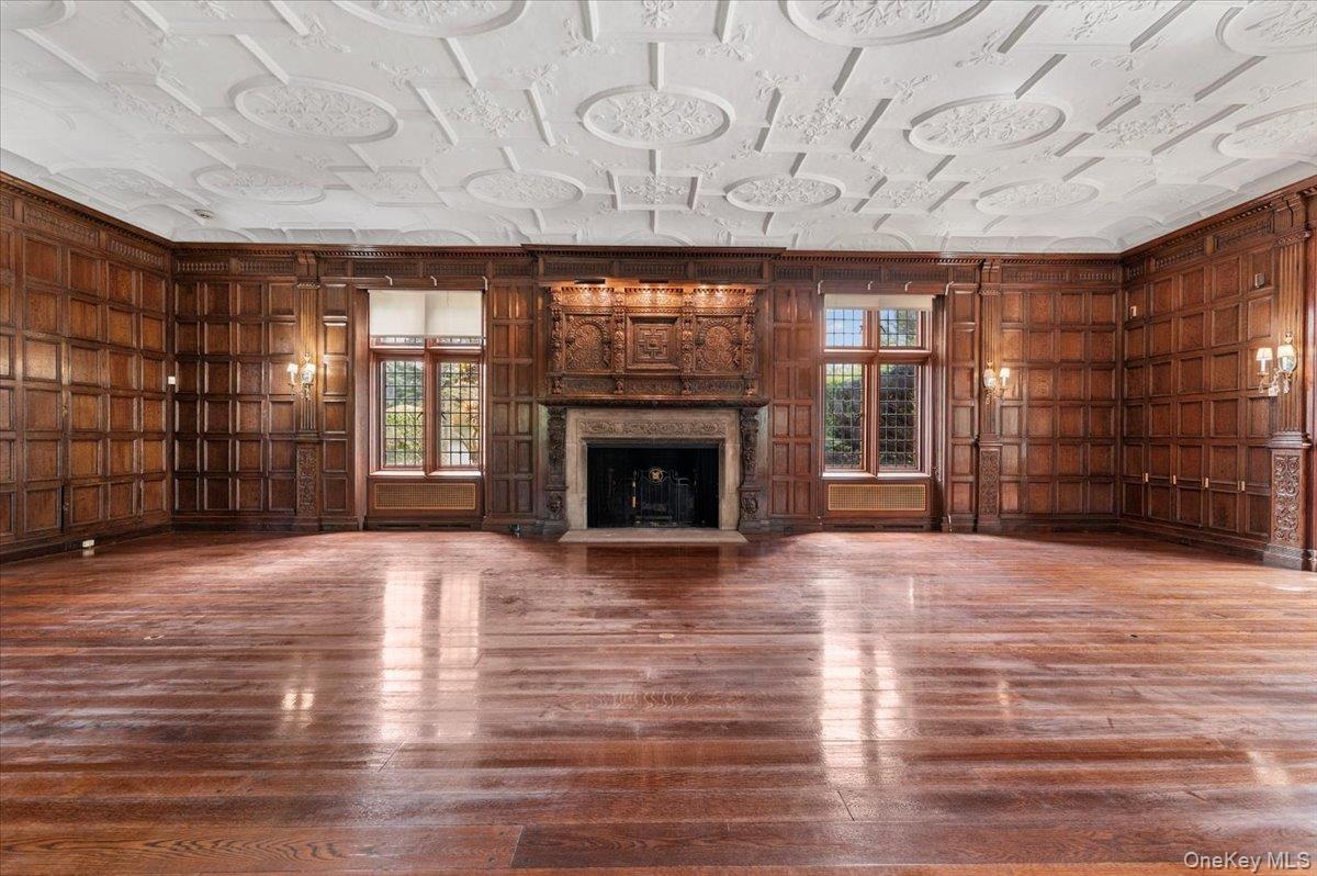127 Horseshoe Road Mill Neck, NY 11765 - Photo 19 of 48 a view of an empty room with a fireplace and a window