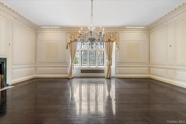 a living room with fireplace furniture and a chandelier