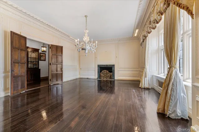 a view of livingroom with furniture wooden floor fireplace and window