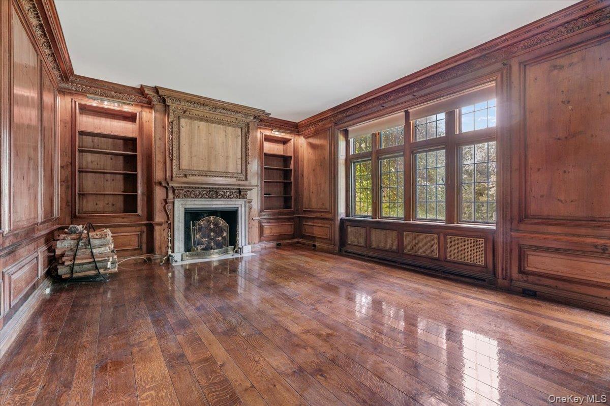 127 Horseshoe Road Mill Neck, NY 11765 - Photo 23 of 48 a living room with furniture a fireplace and wooden floor