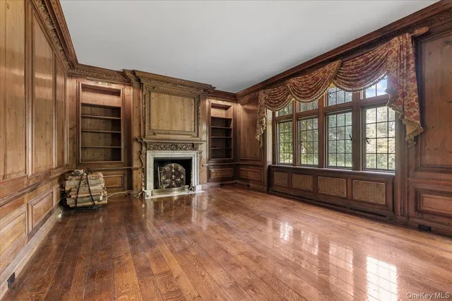 a living room with furniture fireplace and wooden floor