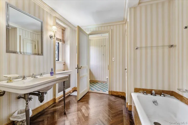 a bedroom with a bed wooden floor and window