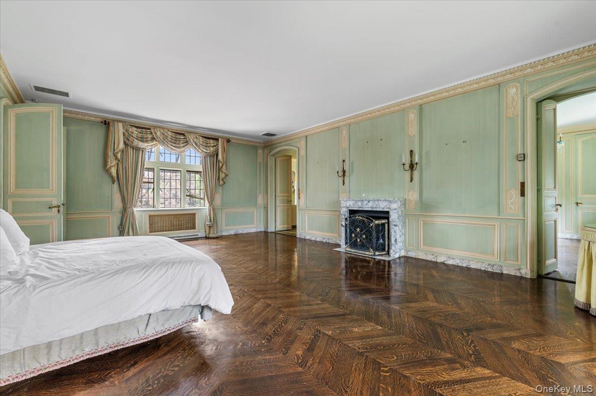 127 Horseshoe Road Mill Neck, NY 11765 - Photo 36 of 48 a spacious bedroom with a bed and a fireplace