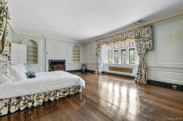 a spacious bedroom with a bed and a fireplace