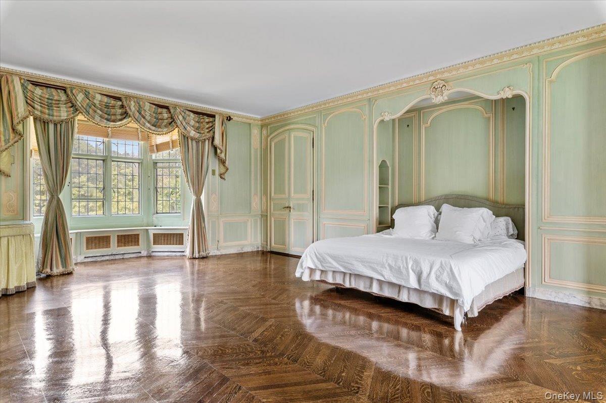 127 Horseshoe Road Mill Neck, NY 11765 - Photo 39 of 48 a spacious bedroom with a bed and wooden floor