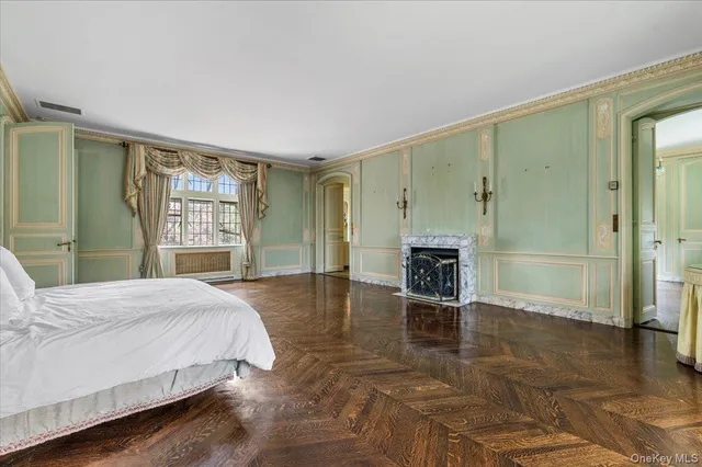 a spacious bedroom with a balcony and large window