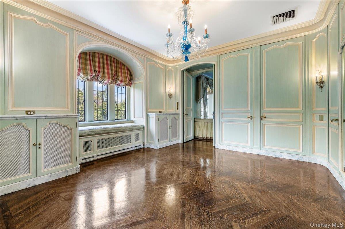 127 Horseshoe Road Mill Neck, NY 11765 - Photo 42 of 48 an empty room with wooden floor a ceiling fan and windows