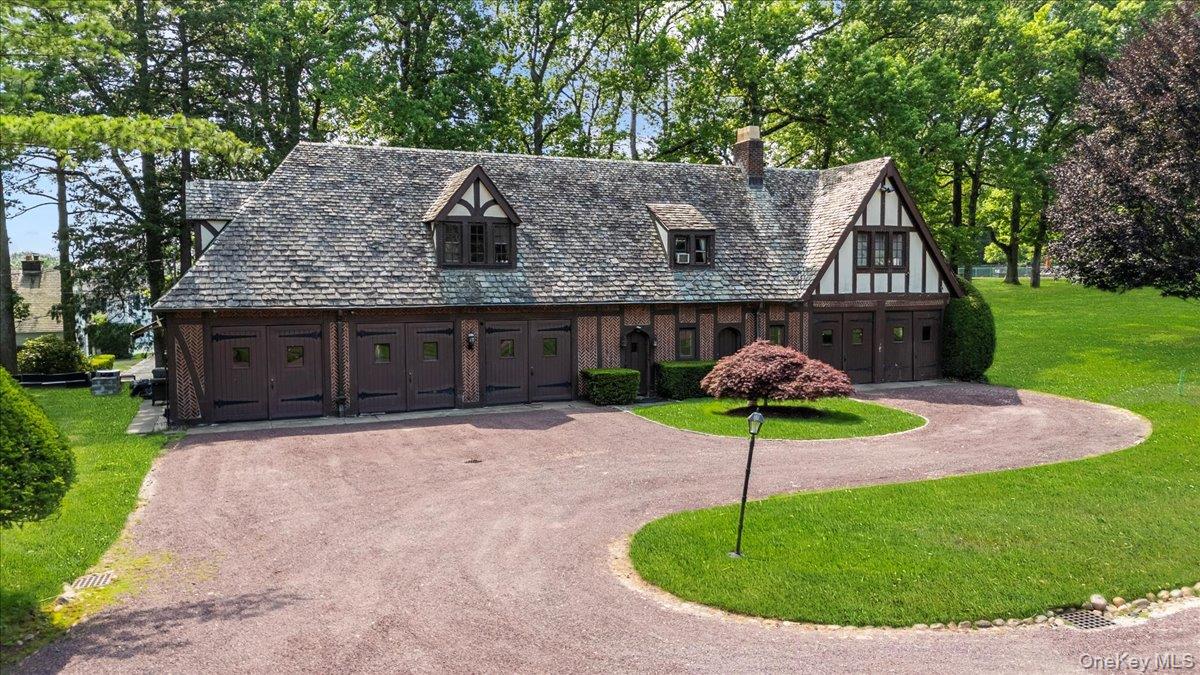 127 Horseshoe Road Mill Neck, NY 11765 - Photo 5 of 48 a house with lots of trees in the background