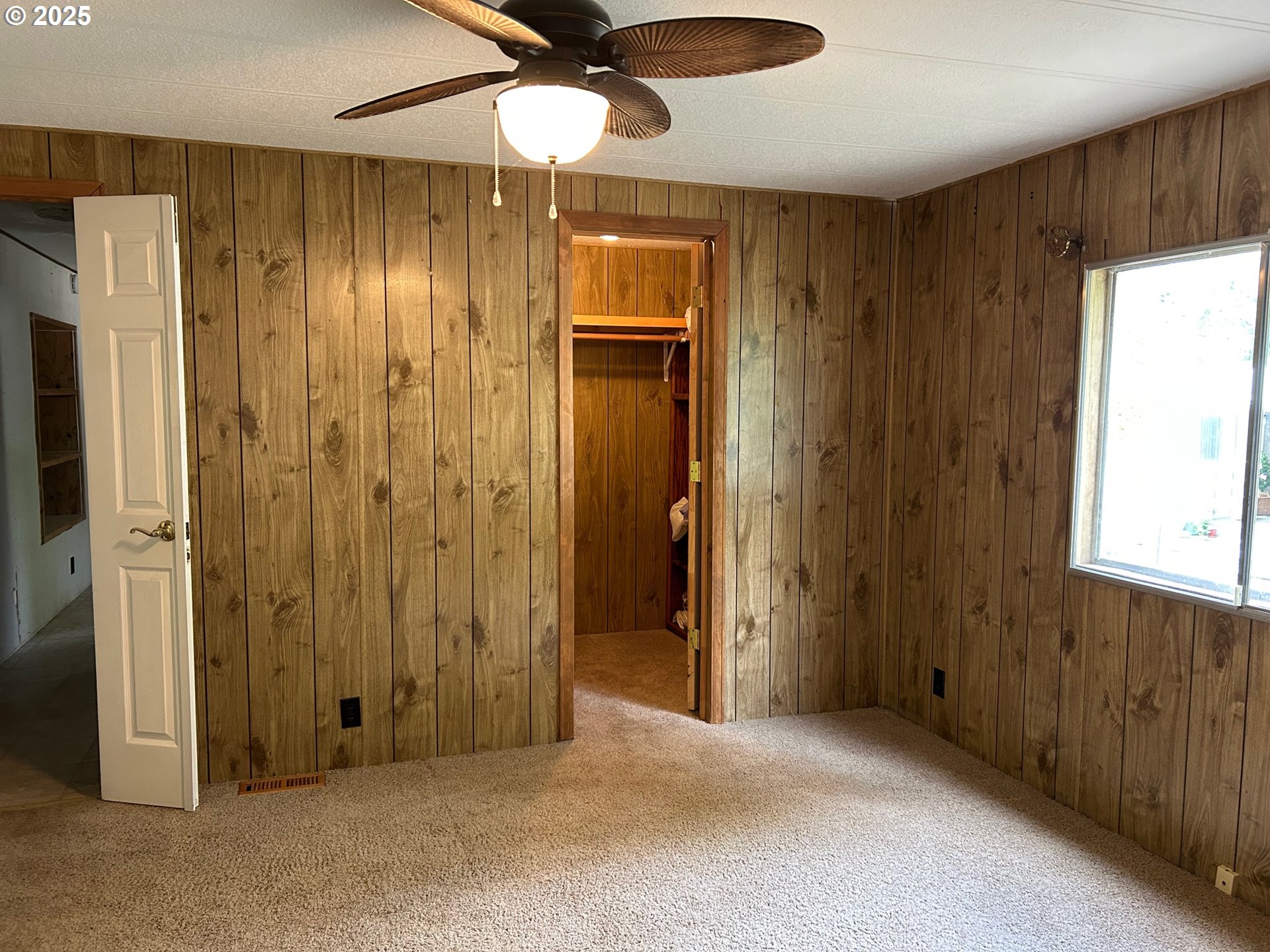 89510 Highway 101, Unit 23 Florence, OR 97439 - Photo 12 of 28 an empty room with closet and a ceiling fan