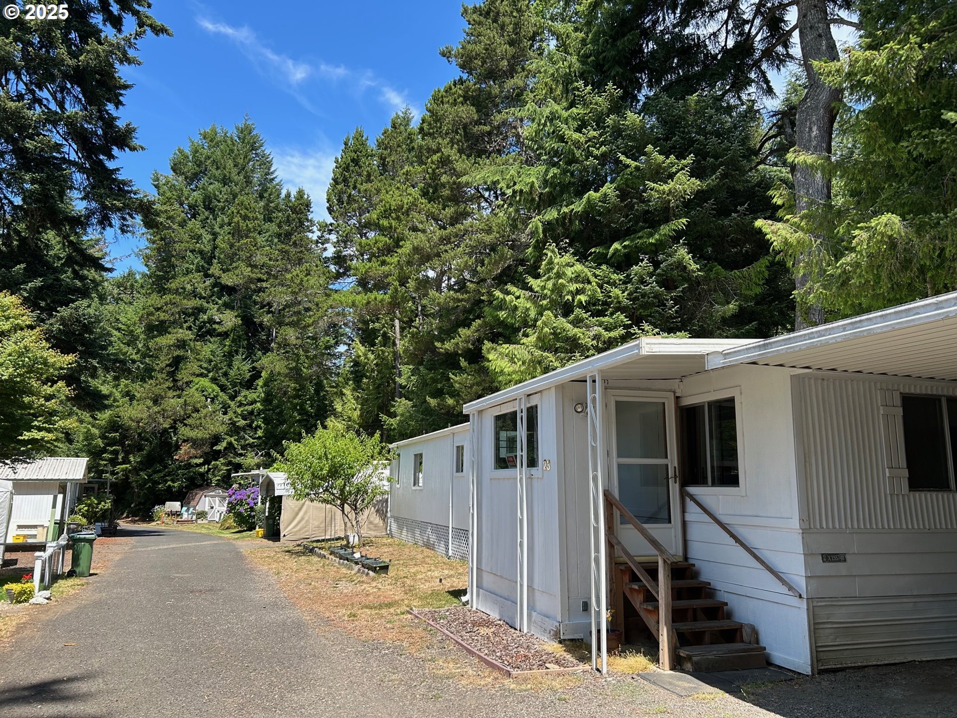 89510 Highway 101, Unit 23 Florence, OR 97439 - Photo 20 of 28 a view of a house with backyard and trees