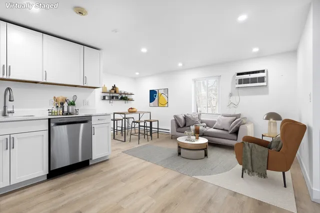 a living room with lots of furniture and white walls