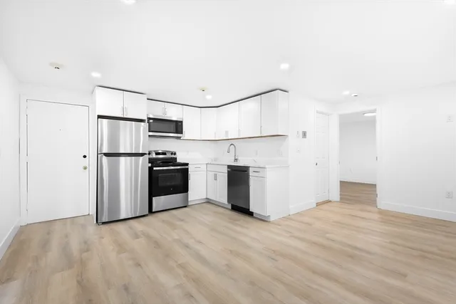 a kitchen with stainless steel appliances a refrigerator and a stove top oven