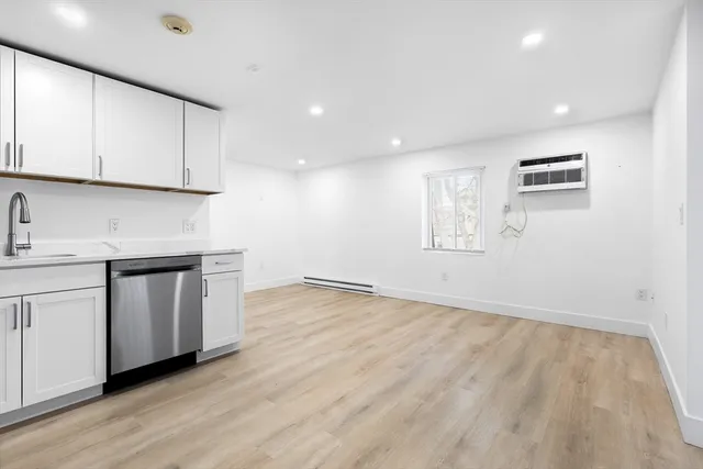 a view of a kitchen with wooden floor and electronic appliances