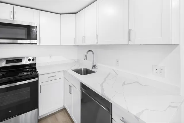 a kitchen with a sink and cabinets