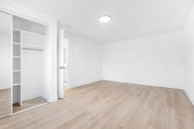 an empty room with wooden floor