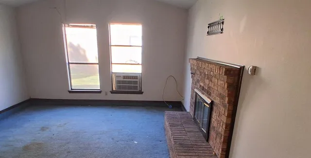 a view of a livingroom with a hardwood and a window