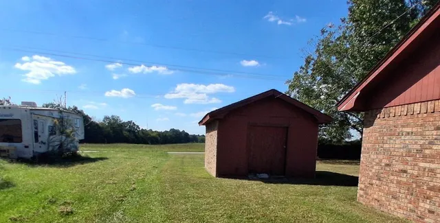 a view of a wooden fence and a pathway