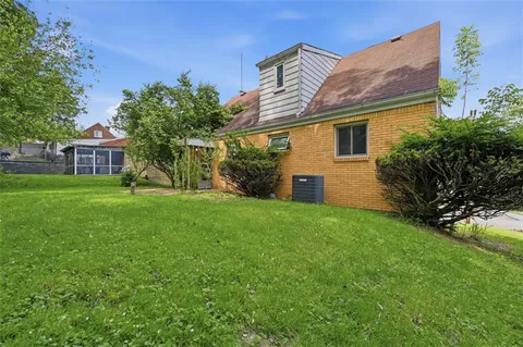a view of a house with a backyard