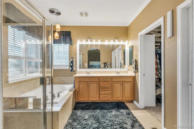 a bathroom with a tub sink and mirror