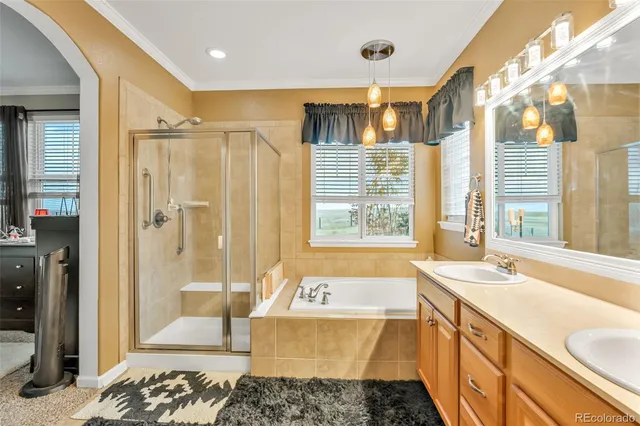 a spacious bathroom with a tub sink and shower
