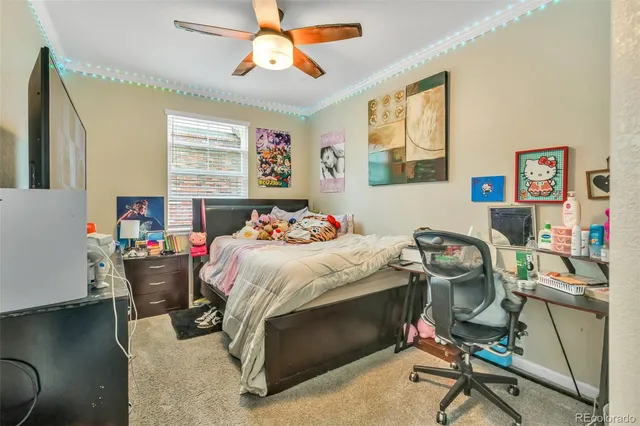 a bedroom with a bed and a desk