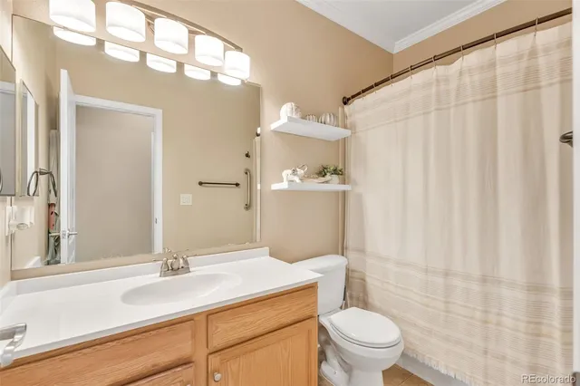 a bathroom with a sink a toilet and shower curtain