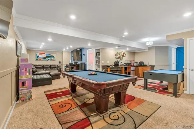 a room with lots of furniture and view of kitchen