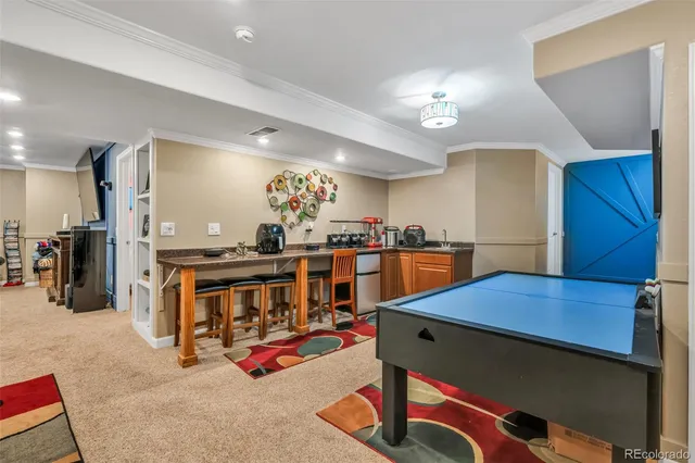 a room with lots of wooden furniture and paintings on the wall