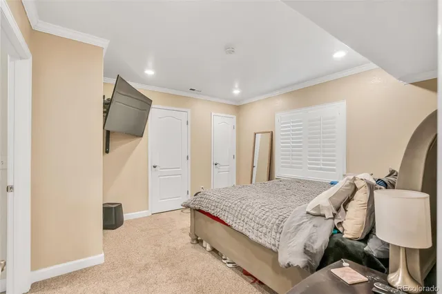 a spacious bedroom with a bed and a flat screen tv