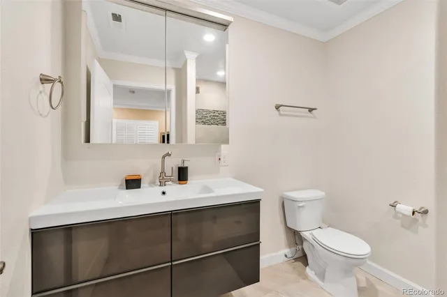 a bathroom with a sink toilet and mirror