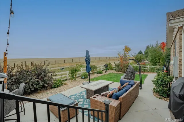 a view of a patio with furniture and a yard