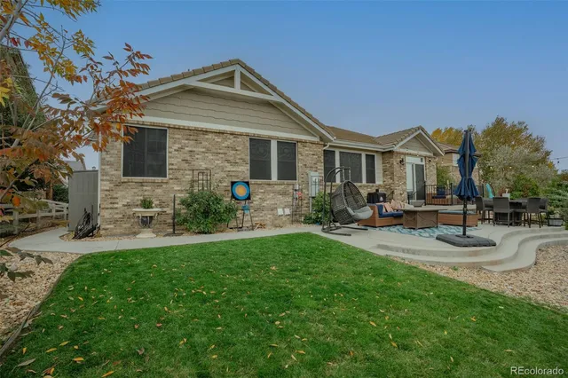 a front view of house with yard and outdoor seating