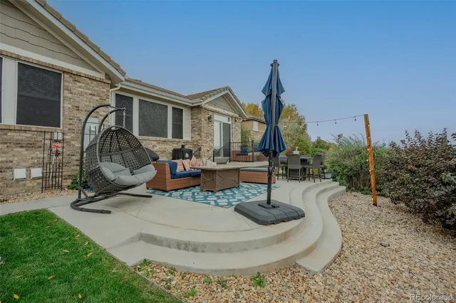 a view of a house with backyard water fountain and sitting area