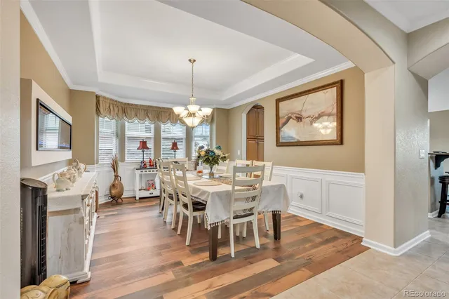 a view of a dining room with furniture wooden floor and chandelier