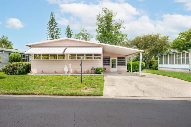 a view of a house with a yard and plants
