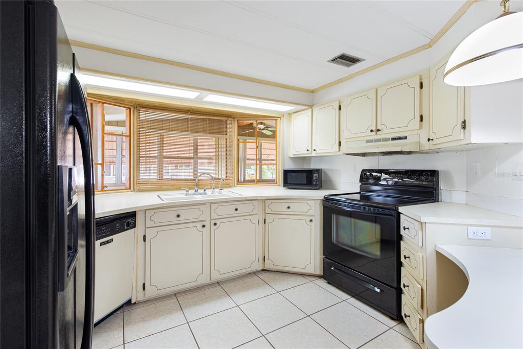 2542 Longpine Lane St. Cloud, FL 34772 - Photo 11 of 35 a kitchen with granite countertop white cabinets and white appliances
